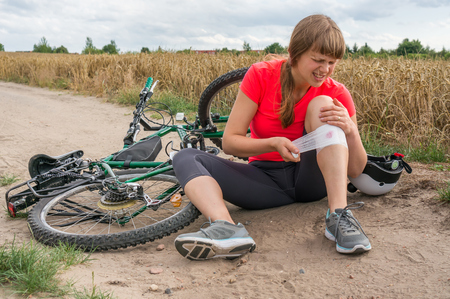 Woman has accident injury after falling from bicycleの写真素材