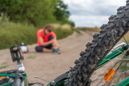 Woman has accident injury after falling from bicycleの写真素材