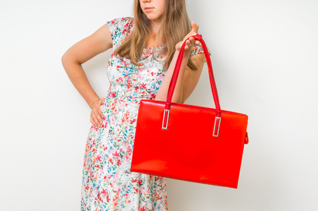 Fashion woman with red handbag isolated on whiteの写真素材