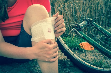 Woman has accident injury after falling down from bicycle - retro styleの写真素材