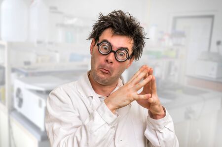 Crazy scientist with glasses thinking about his experiment in laboratoryの写真素材