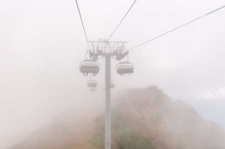 Cable car and fog in the russian mountainsの写真素材