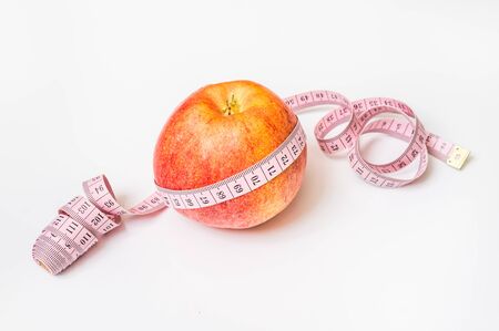 Red apple with measuring tape - diet concept with appleの写真素材