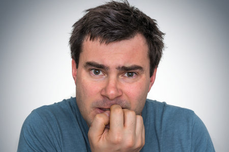 Nervous man biting his nails - nervous breakdown concept