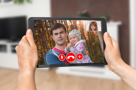 Woman online talking with her family - video call conceptの写真素材