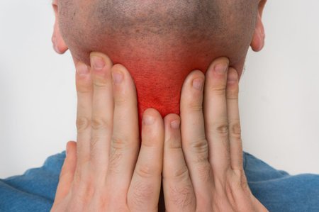 Man with throat sore is holding his aching throat - body pain concept