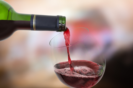 Red wine pouring into a wine glass - celebration conceptの写真素材
