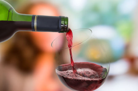 Red wine pouring into a wine glass - celebration conceptの写真素材