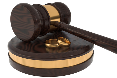 Divorce concept with wooden gavel and gold wedding rings. 3D rendered illustration.の写真素材