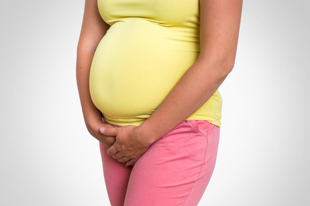 Pregnant woman with frequent urination problem - pregnancy conceptの写真素材