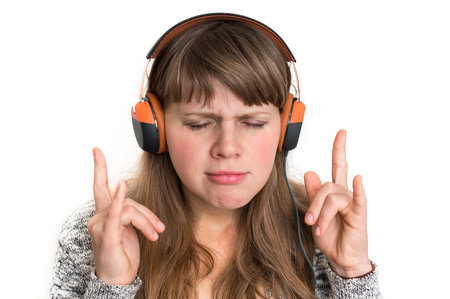 Pretty woman with headphones is listening rock musicの写真素材