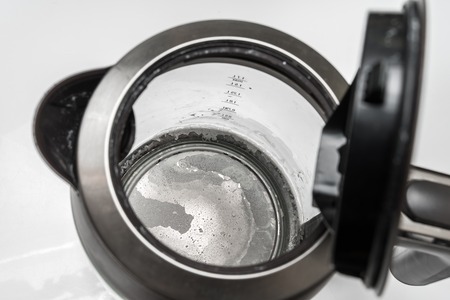 Limescale at the bottom of kettle - hard water and calcium conceptの写真素材