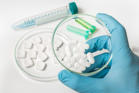 Pills in petri dish in laboratory - medical conceptの写真素材