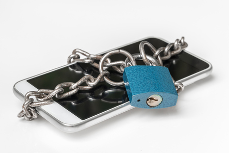Chained smartphone with lock - mobile phone security conceptの写真素材