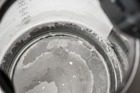 Limescale at the bottom of kettle - hard water and calcium conceptの写真素材