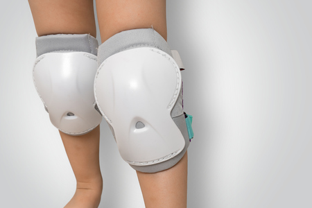 Pair of knee pads wearing on legs of child - protectors for kneesの写真素材