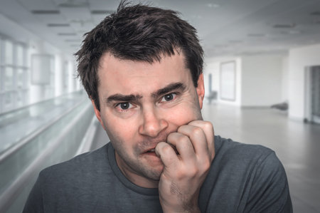 Nervous man biting his nails - nervous breakdown concept