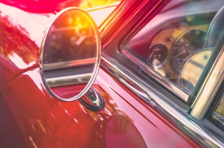 Round side mirror of a red retro carの写真素材