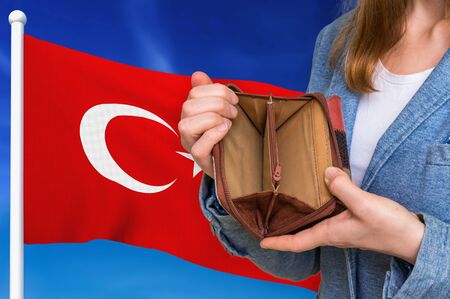 Finance problem in Turkey. Poor person with empty wallet on national flag background.の写真素材