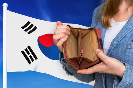 Finance problem in South Korea. Poor person with empty wallet on national flag background.
