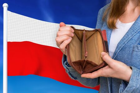 Finance problem in Poland. Poor person with empty wallet on national flag background.の写真素材