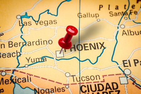 PRAGUE, CZECH REPUBLIC - JANUARY 12, 2019: Red thumbtack in a map. Pushpin pointing at Phoenix city in Arizona, America.の写真素材