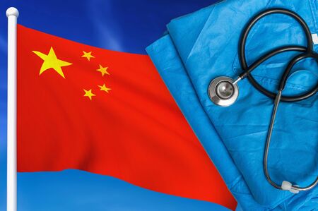 Health care in China. Stethoscope and medical uniform on national flag background.の写真素材