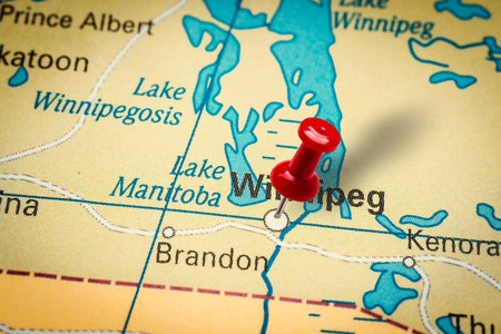 PRAGUE, CZECH REPUBLIC - JANUARY 12, 2019: Red thumbtack in a map. Pushpin pointing at Winnipeg city...