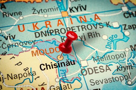 PRAGUE, CZECH REPUBLIC - JANUARY 12, 2019: Red thumbtack in a map. Pushpin pointing at Chisinau city in Moldova.の写真素材