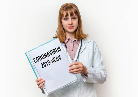 Female doctor showing medical clipboard with written text: Coronavirusの写真素材