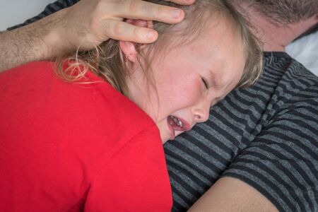 Sad child crying on father's chest - family conceptの写真素材