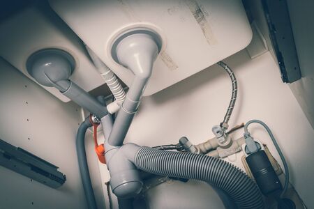 Clogged siphon under the sink in kitchen - retro styleの写真素材