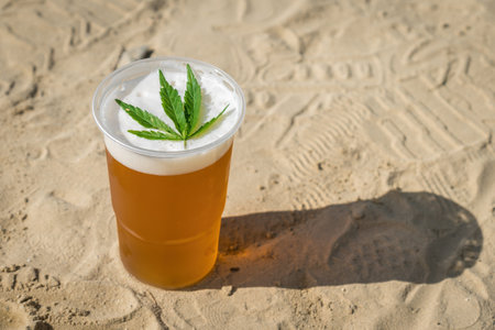 Cannabis beer with herbal leaf of marijuana on the foam surfaceの写真素材