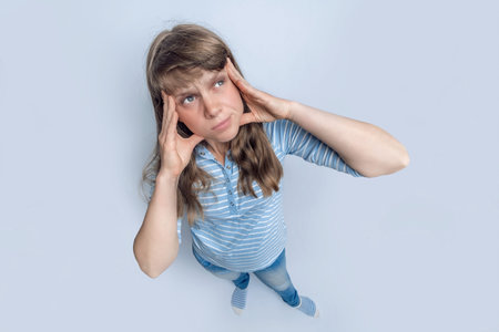 Up view of standing woman with emotional face grimace on isolated background