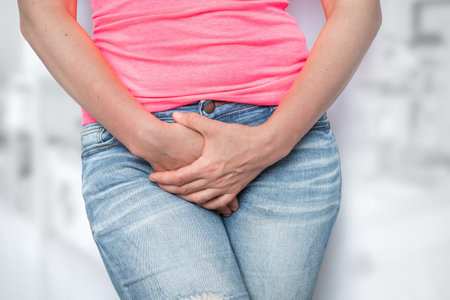 Woman with hands holding her crotch, she wants to pee - urinary incontinence concept