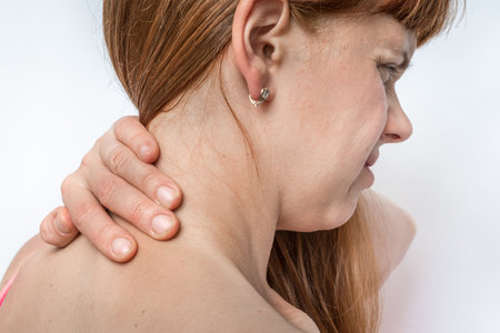 Woman with muscle injury having pain in her neck - body pain conceptの写真素材