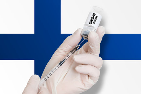 Vaccination in Finland. Vaccine to protect against Covid-19 on background of national flag.の写真素材