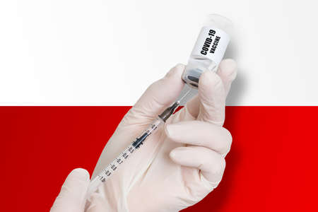 Vaccination in Poland. Vaccine to protect against Covid-19 on background of national flag.の写真素材