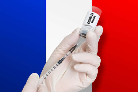 Vaccination in France. Vaccine to protect against Covid-19 on background of national flag.の写真素材