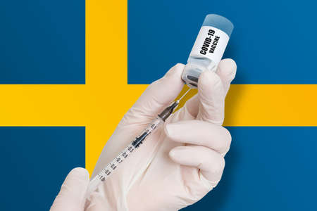 Vaccination in Sweden. Vaccine to protect against Covid-19 on background of national flag.の写真素材
