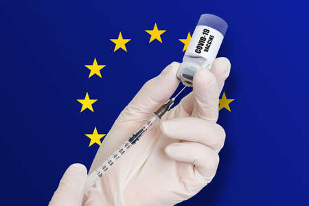 Vaccination in European Union. Vaccine to protect against Covid-19 on background of national flag.の写真素材