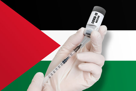 Vaccination in Palestine. Vaccine to protect against Covid-19 on background of national flag.の写真素材