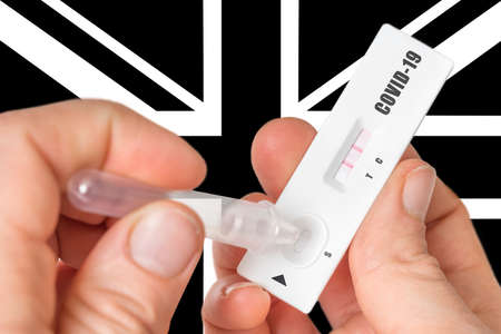 Positive rapid test on COVID-19 in United Kingdom on black and white background of national flagの写真素材