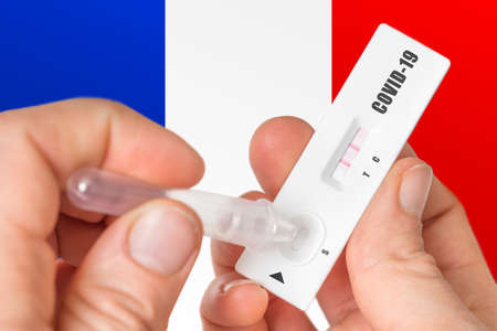 Positive rapid test on COVID-19 in France on background of national flagの写真素材
