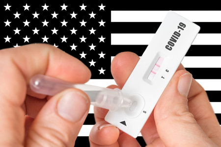Positive rapid test on COVID-19 in United States of America on black and white background of national flagの写真素材