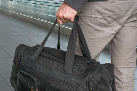 Man with bag in hall of airport - travel conceptの写真素材