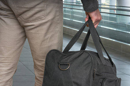Man with bag in hall of airport - travel conceptの写真素材