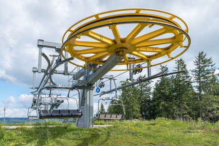 Spinning wheel with electric cable hoist motor in a ski resort in summerの写真素材
