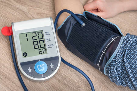 Blood pressure monitor with normal pressure level on screenの写真素材