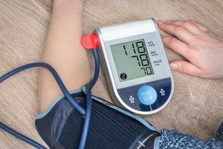 Blood pressure monitor with normal pressure level on screenの写真素材